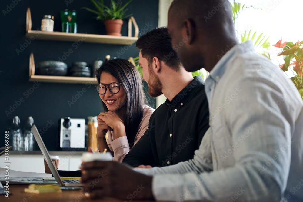 Diverse group of smiling colleagues working together in an office