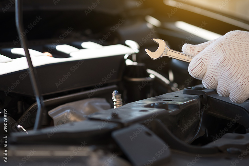 Mechanic repairing a car in garage Auto repair car engine, close u Mechanic repairing a car in garage Auto repair car engine, close u