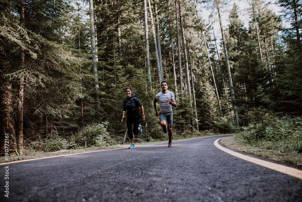 Couple running in the forest Couple running in the forest