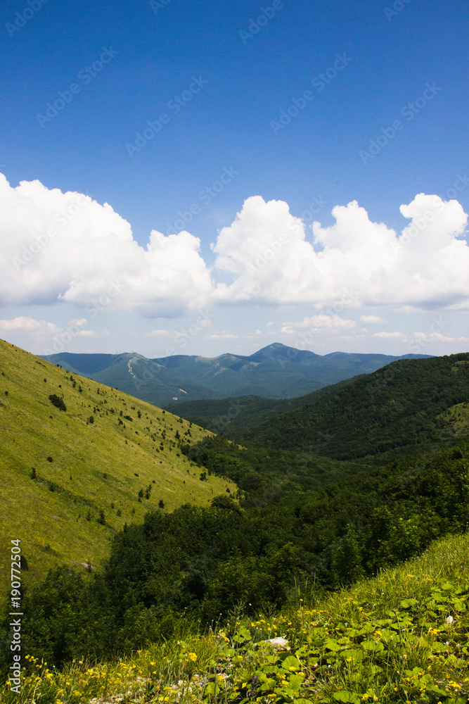 Green slope of the mountain. Panorama view of the mountains.