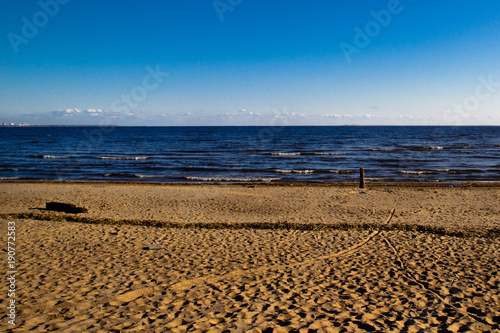 Deep blue sea water at the beach of the Baltic sea washing the sandy coastline