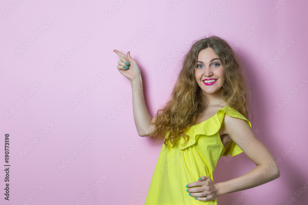 Happy woman on pink background pointing at advertising Happy woman on pink background pointing at advertising