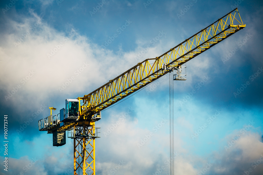 Construction crane against cloudy blue sky. Construction crane against cloudy blue sky.
