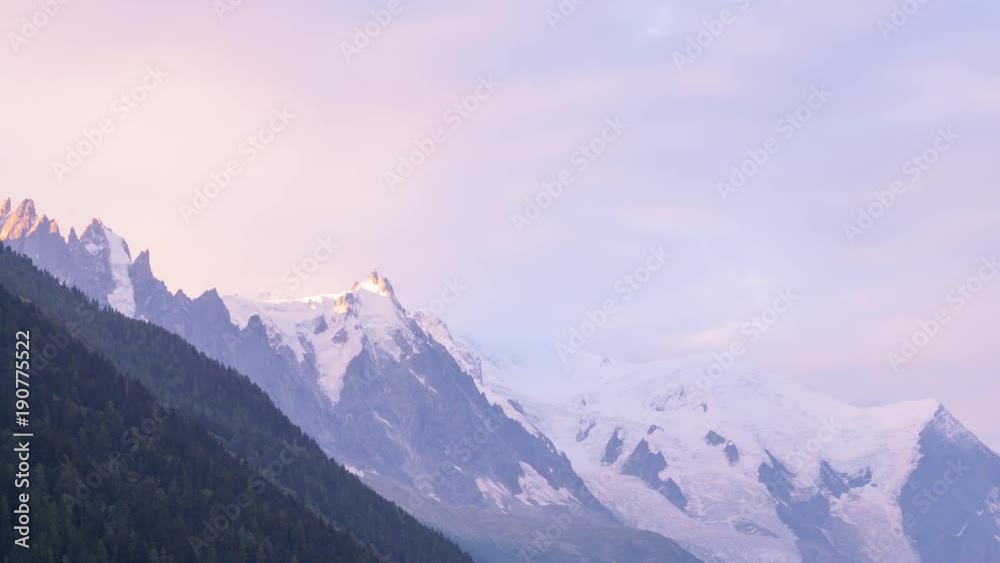 Picturesque timelapse of sunrise at the Mont Blanc range mountains with beautiful colorful dramatic sky, view to the Aiguille du Midi peak, France. Picturesque timelapse of sunrise at the Mont Blanc range mountains with beautiful colorful dramatic sky, view to the Aiguille du Midi peak, France.