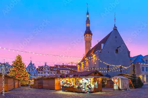 Decorated and illuminated Christmas tree and Christmas Market at Town Hall Square or Raekoja plats at beautiful sunrise, Tallinn, Estonia.