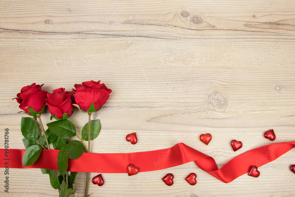 Red roses and a hearts on wooden table, Valentines Day background, wedding day