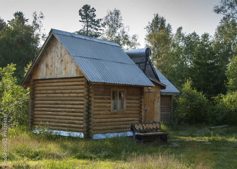 log house in the woods with solar panels on the roof log house in the woods with solar panels on the roof