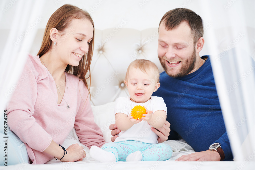 Parenting family. Mother and father playing with little newborn baby Parenting family. Mother and father playing with little newborn baby