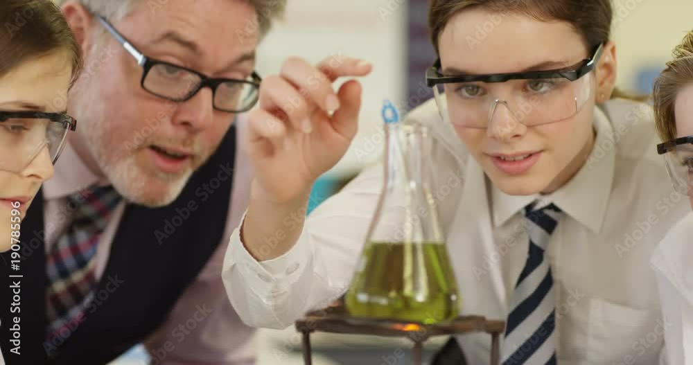 4k, Close-up shot of a teacher explaining an experiment to a high school chemistry class. Slow motion. 4k, Close-up shot of a teacher explaining an experiment to a high school chemistry class. Slow motion.