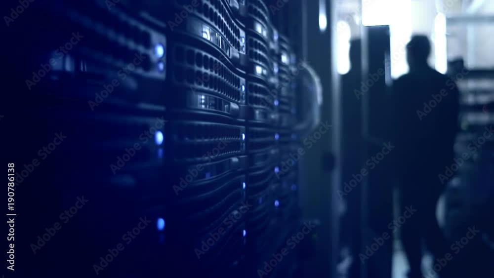 System engineer in the server room. Data center with a lot of network equipment