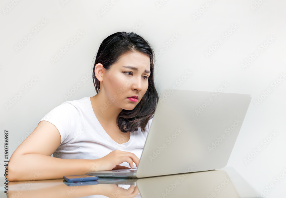 asian woman look at laptop with sad feeling asian woman look at laptop with sad feeling