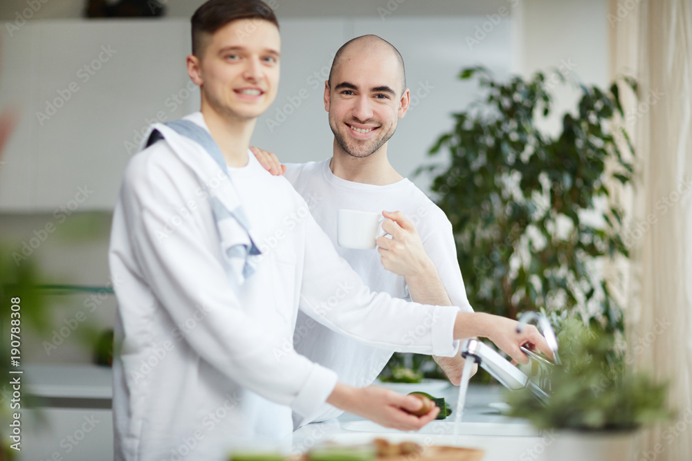 Two happy gay men in homewear spending morning in the kitchen Two happy gay men in homewear spending morning in the kitchen