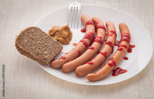 frankfurters topped with ketchup and mustard. photo