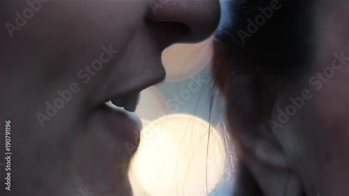 Woman whispering Something Outdoors. Bokeh Background. Close-Up. 