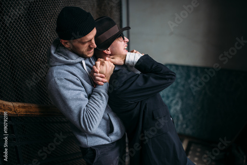 Tablou pe pânză Robber tries to strangle his victim in entrance