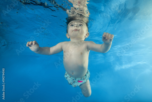 little boy learns to dive underwater in the pool © Andriy Nekrasov