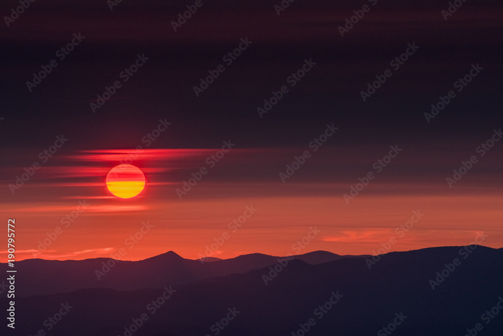 Fototapeta premium Sun Slips Through Wispy Clouds