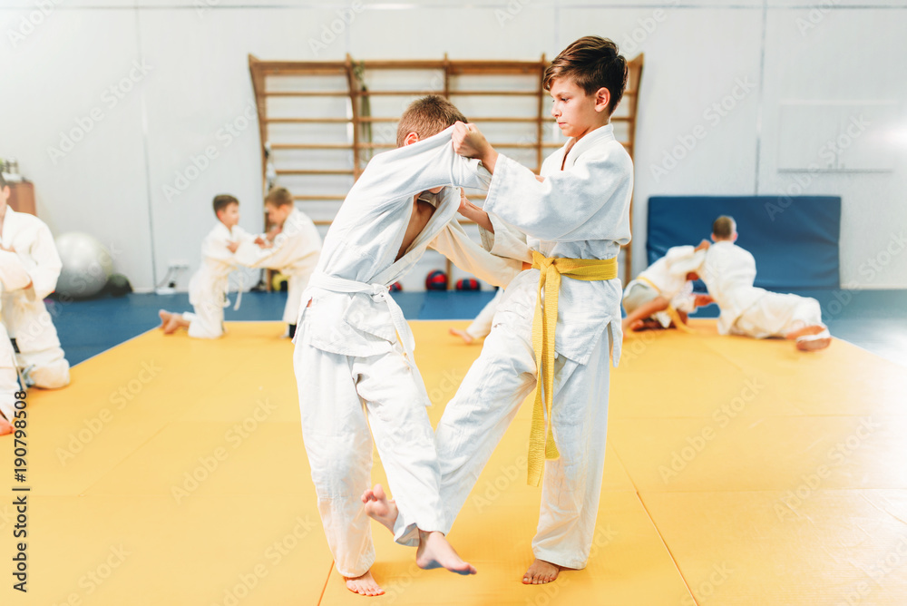 Foto Stock Boys in kimono fights, kid judo training | Adobe Stock