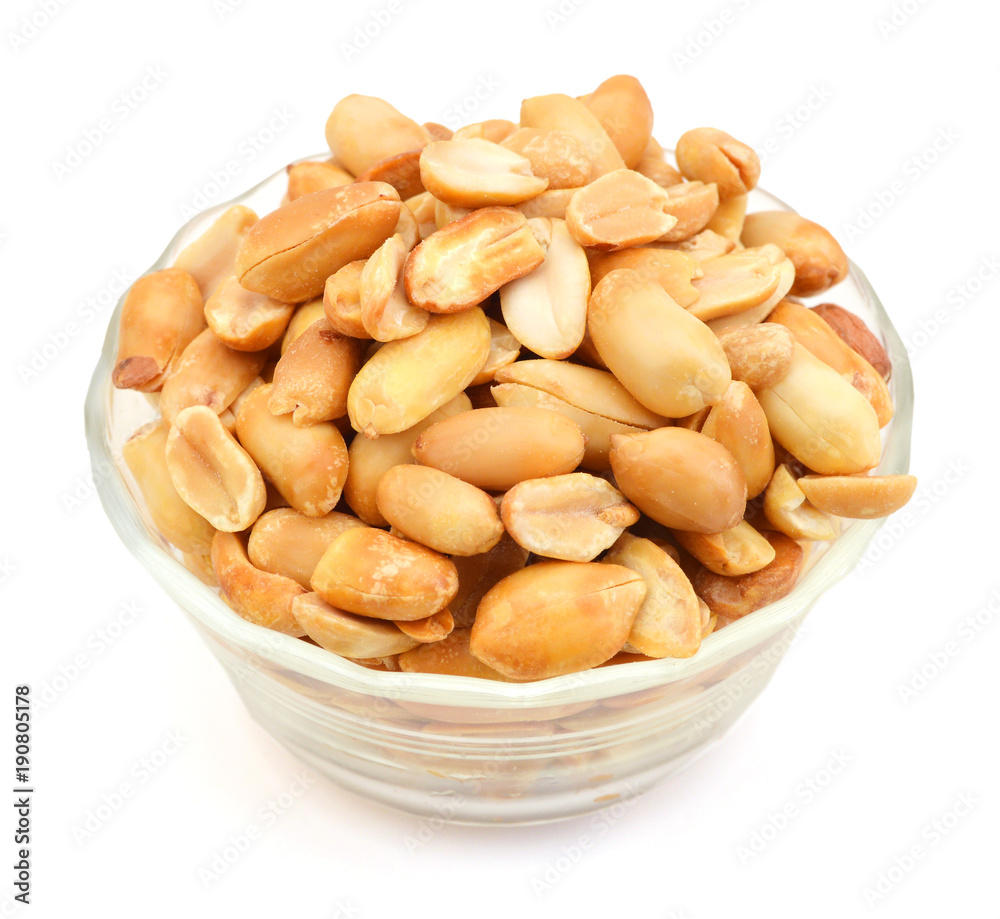 Processed peanuts isolated in glass bowl on white background Processed peanuts isolated in glass bowl on white background