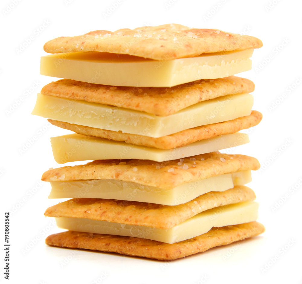 Fototapeta premium Delicious crackers with cheese on white background