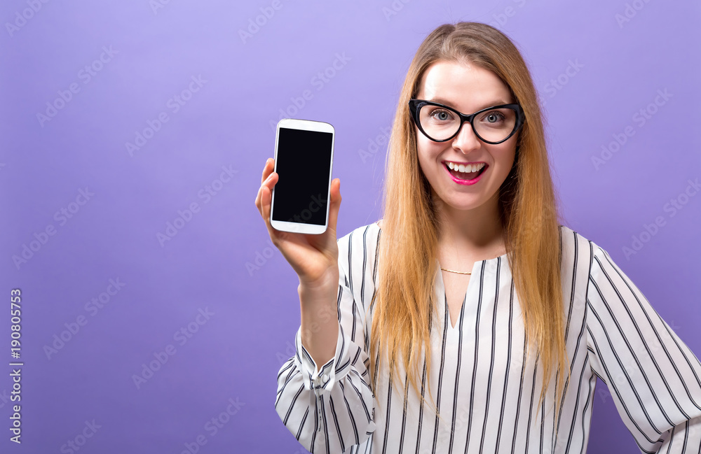 Young woman holding out a cellphone in her hand Young woman holding out a cellphone in her hand