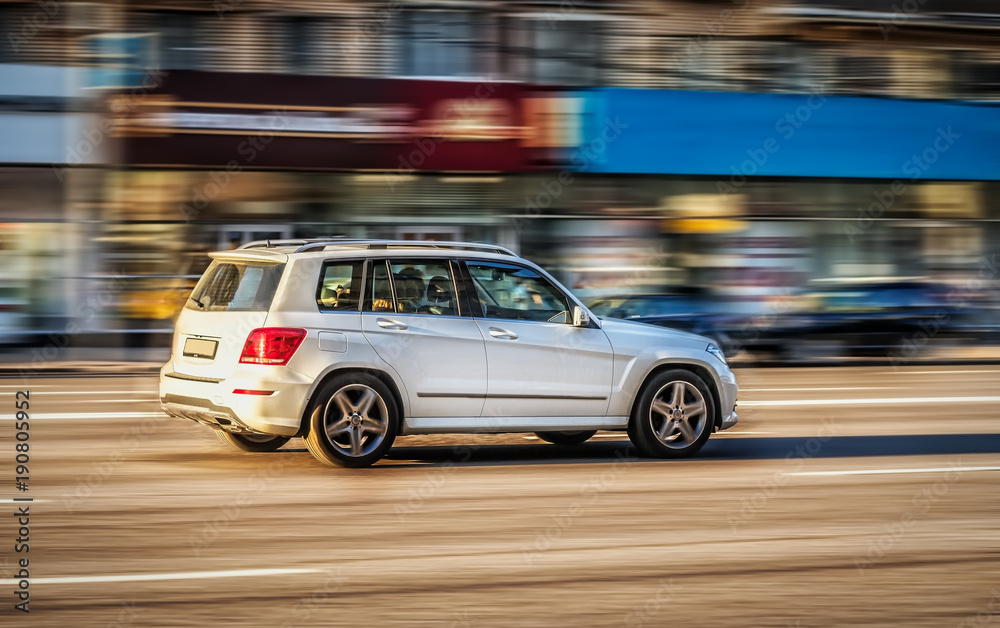 A car moves along the street of a city. Blurred background. Motion blur