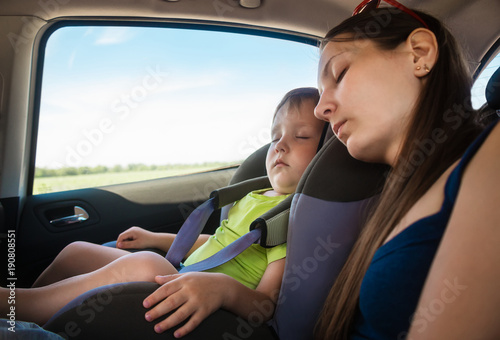 Mom and son sleeping in the car © Svetlaya