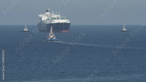 Pilot and tug boat near LNG tanker