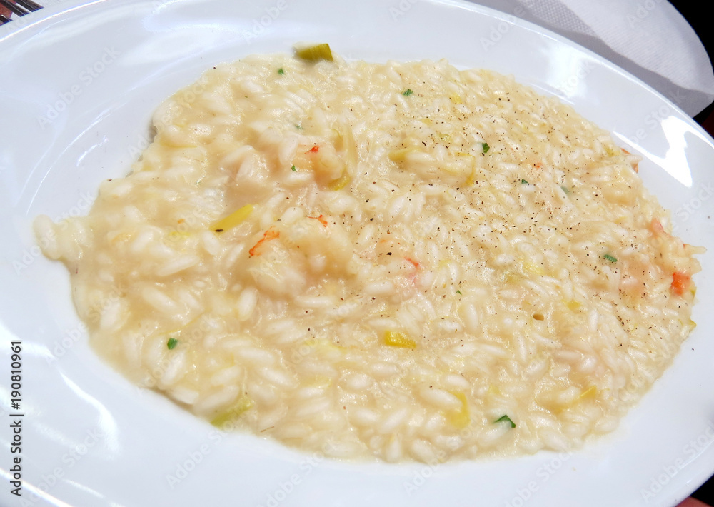 Seafood risotto on white plate