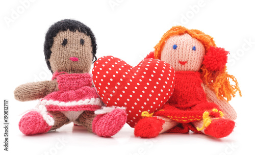 Photo Knitted dolls and toy heart.