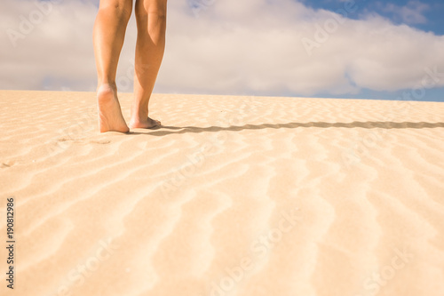 Fototapeta Naklejka Na Ścianę i Meble -  barefoot woman legs walking on the sand