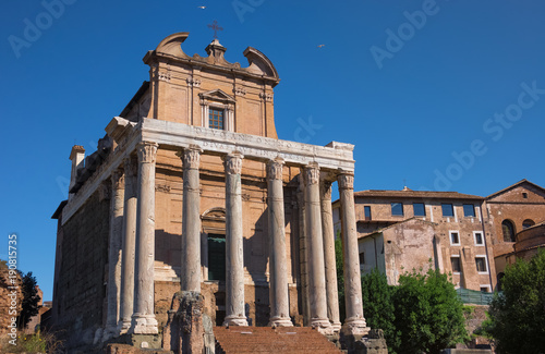 Antonin and Faustine temple on contrast blue sky background in Rome, Italy photo