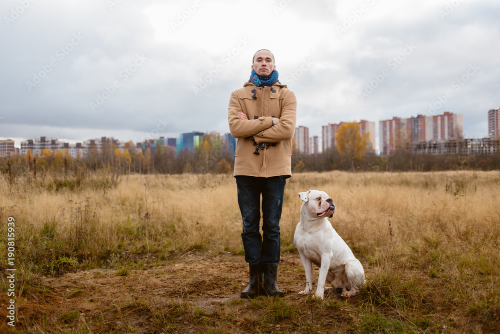 Man training dog on lawn