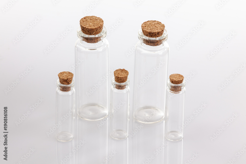 Glass container with cork stopper on white background. Glass container with cork stopper on white background.