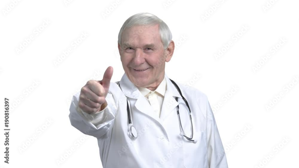 Senior doctor shows thumb up in white isolated background. Old therapist with grey hair showing thumb up and rotating. Senior doctor shows thumb up in white isolated background. Old therapist with grey hair showing thumb up and rotating.