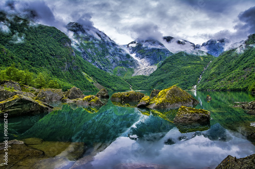 Amazing lake on a background of mountains and glacier. Norway. Beautiful landscape. Artistic picture. Beauty world.