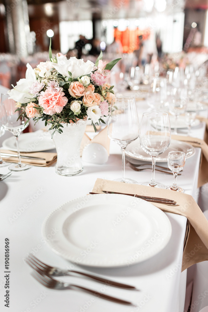 Tables set for an event party or wedding reception. luxury elegant table setting dinner in a restaurant. glasses and dishes.