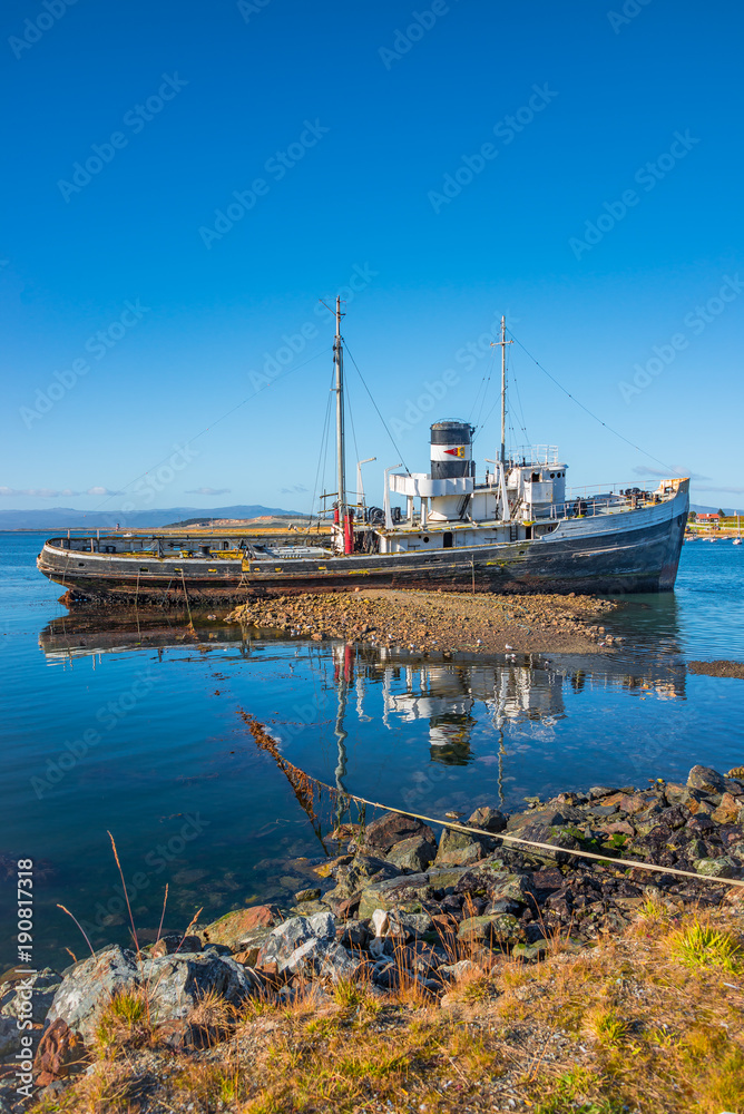 Old sunken boat in the harbor in Ushuaia, Patagonia, Argentina