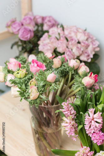 Flower shop concept. Different varieties fresh spring flowers in refrigerator room for flowers. Bouquets on shelf, florist business.