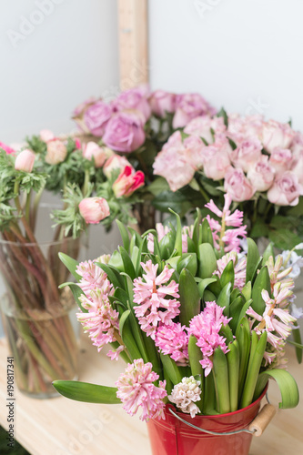 Flower shop concept. Different varieties fresh spring flowers in refrigerator room for flowers. Bouquets on shelf, florist business.