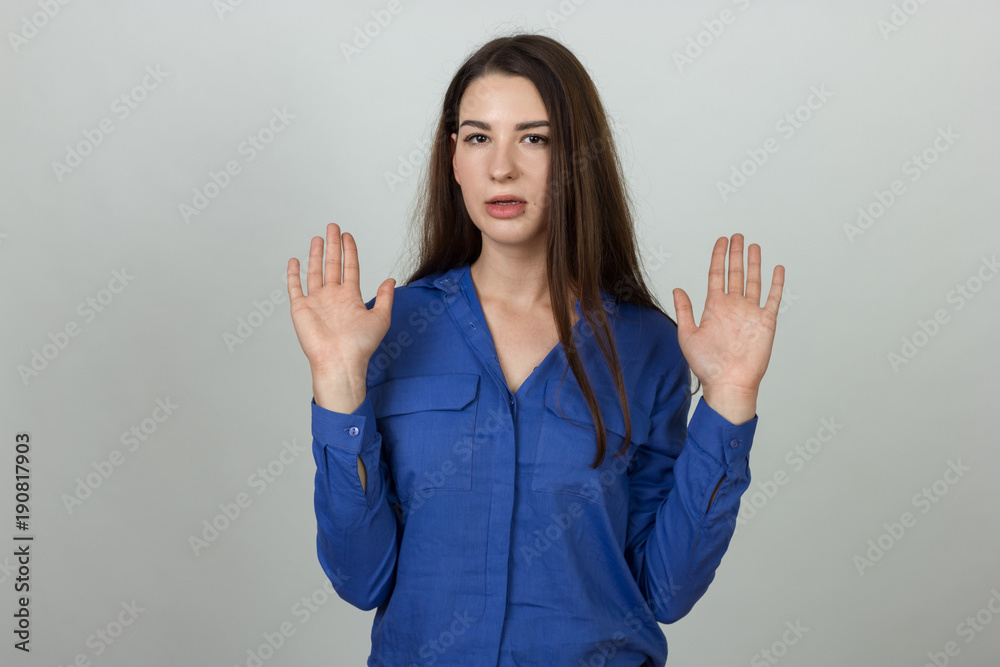 Woman standing with raised hands aside shrugging shoulders not having courage to make decision Woman standing with raised hands aside shrugging shoulders not having courage to make decision