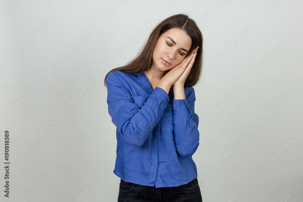 Portrait of a pretty woman pretends to be asleep in her arms Portrait of a pretty woman pretends to be asleep in her arms