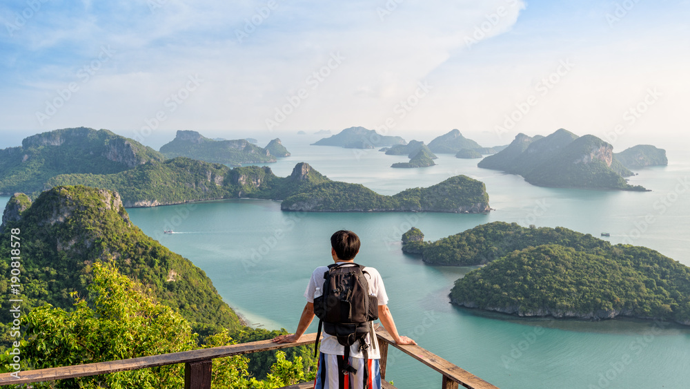 Naklejka premium Backpack Asian man on the mountain see view panorama the beautiful nature landscape of the sea adventure on vacation travel leisure to Asia on Mu Ko Ang Thong island National Park background, Thailand