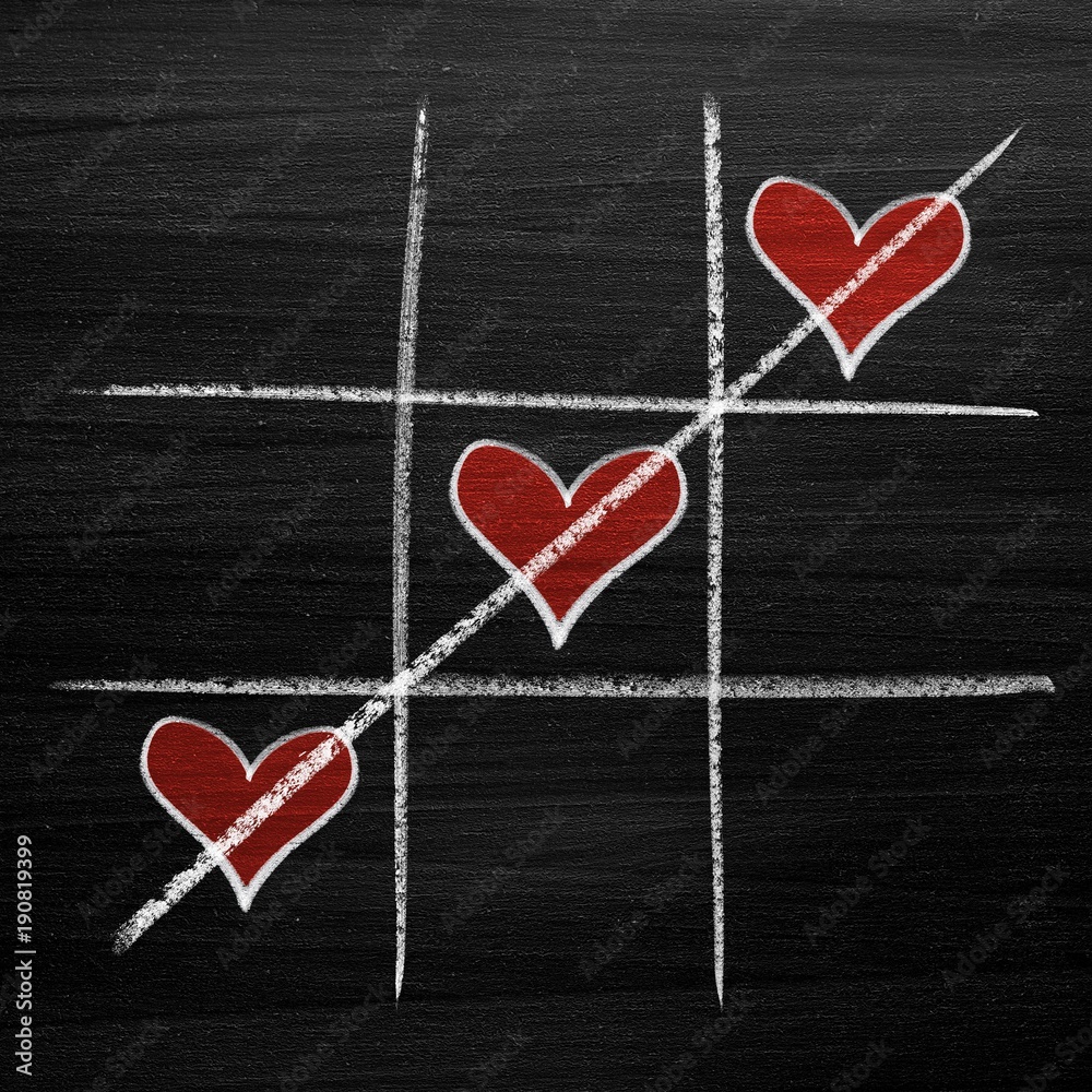 Tic tac toe game with chalk hearts, XO noughts and crosses Valentine's Day style Tic tac toe game with chalk hearts, XO noughts and crosses Valentine's Day style