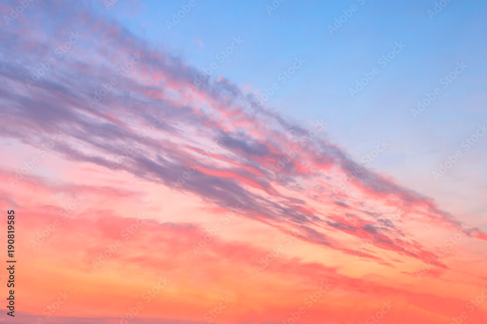 red colorfully sunset with blue areas and purple feather clouds