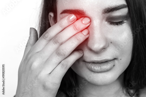 Pain. Tired Exhausted Stressed Woman Suffering From Strong Eye Pain. Black and white with a red accent