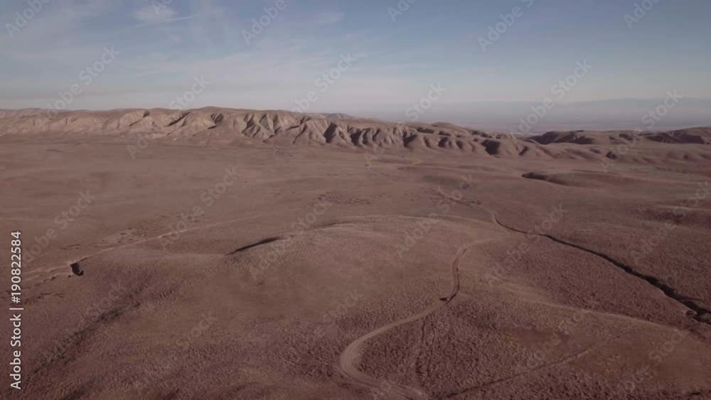 Car driving along desert road, California Car driving along desert road, California