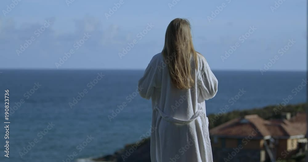 attractive woman getting into the swimming pool at villa with ocean view attractive woman getting into the swimming pool at villa with ocean view