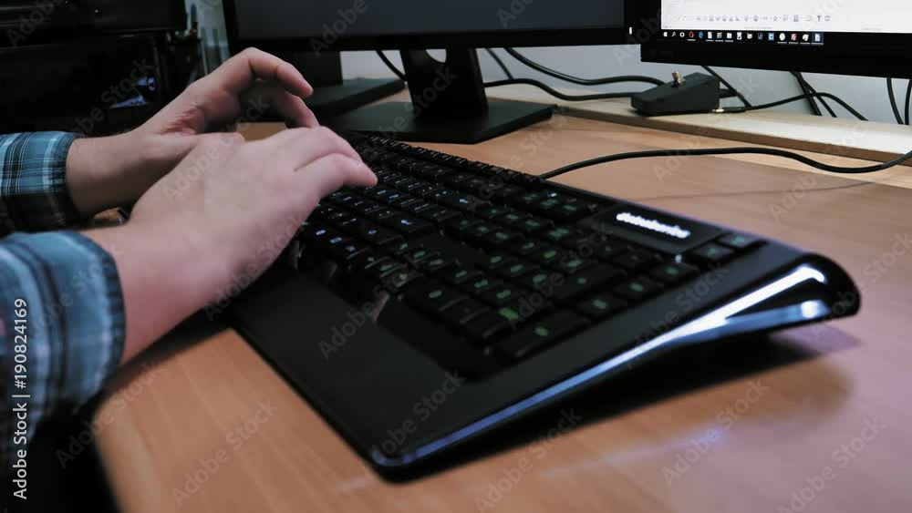 Man typing on modern illuminated computer keyboard. Man typing on modern illuminated computer keyboard.