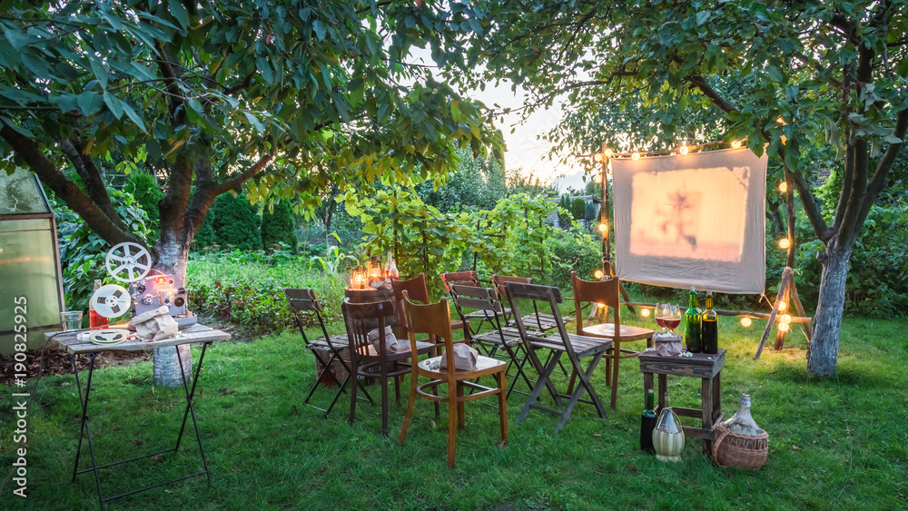 Summer cinema with retro projector in the evening